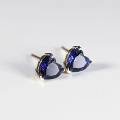 These earrings feature a heart-shaped lab grown blue sapphire stone that sparkles and shines in the light. The heart shape of the sapphire stones adds a touch of romance and whimsy to the design, making them perfect for both casual and formal events. DETAILS ABOUT THE EARRINGS AND MATERIAL AND STONE * 14k SOLID GOLD Settings, posts and backings * 5x5mm heart shaped genuine lab grown blue sapphire ** All our raw materials are sourced from US-based companies for the quality and safety of our handm Blue Heart-cut Heart Earrings For Anniversary, Blue Heart Cut Earrings For Anniversary, Blue Heart-shaped Earrings For Anniversary, Blue Sterling Silver Heart Cut Earrings, Elegant Blue Heart Earrings For Anniversary, 14k Gold Heart Cut Birthstone Earrings, Blue Sapphire Earrings, Blue Sapphire Stone, Sapphire Stud Earrings