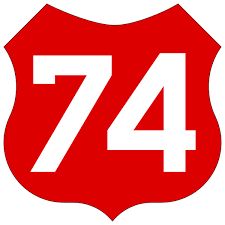 a red and white highway sign with the number 74 on it's side in front of a white background