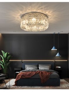 a bedroom with a large bed and chandelier above the headboard is lit by blue lights