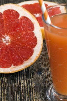 grapefruit and orange juice on a wooden table