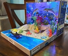 an open box with sea life on it sitting on a table