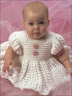 a baby doll wearing a white crochet dress