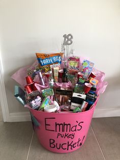 a pink bucket filled with lots of different items