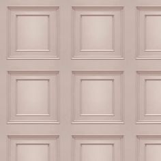 the wall is made up of many different square shapes and sizes, all in pale pink