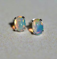 Beautiful blue toned opal post earrings. These earrings have a rainbow hue and glittery pinfire stripe going through one opal. These are a gorgeous pair. Opal size: 9 x 7 mm Sterling silver Posts Blue Sparkle, Blue Sparkles, Blue Opal, A Rainbow, Beautiful Blue, Post Earrings, Opal, Sparkle, Stud Earrings