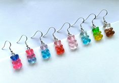 Gummy bear gradient glitter resin dangle earrings. Stainless steel ear wire hook. Hypoallergenic. Great for those with sensitive ears! Many different colors available! Please reference the photos to choose a gummy bear color. Colors may vary slightly from photos as these are a handmade item. I put a lot of time and effort into researching and purchasing the best products to provide quality jewelry at a great price. Due to the nature of these items, I will not be accepting returns or exchanges for any earrings. I do not want to risk reselling a pair of earrings that have potentially been worn. If there are any issues with the product, please contact me for a resolution. Candy Earrings, Bear Earrings, Gummy Bear, Earrings Cute, Gummy Bears, Matching Necklaces, Sensitive Ears, Cute Earrings, Ear Wire