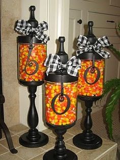 three glass jars with candy in them sitting on a counter