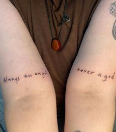 two people with tattoos on their arms that say, always an angel never a god