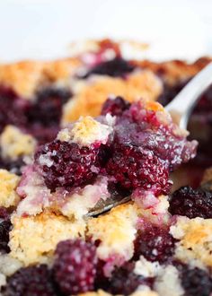 a close up of a plate of food with blueberries and crumbs on it