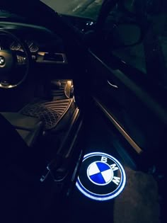 the interior of a bmw car with its lights on