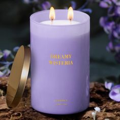 a purple candle sitting on top of a wooden table