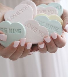 four heart shaped candys with the words be mine written on them