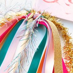 a bunch of ribbons that are next to each other on a table with confetti sprinkles