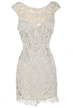 a white lace dress on a mannequin neckline with an open back and short sleeves