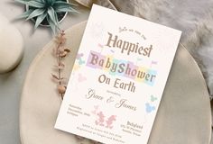 a baby shower sign on a plate next to flowers