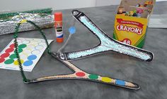 a pair of scissors sitting on top of a table next to other crafting supplies