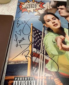 an autographed poster is displayed on a table