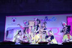 a group of people standing on top of a stage