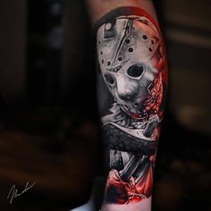 a person with a tattoo on their arm wearing a mask and holding a knife in his hand