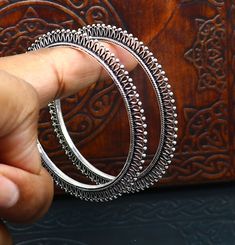 Silver Jewelry With Intricate Design For Diwali, Antique Silver Bangle With Oxidized Finish, Antique Silver Oxidized Bangle, Antique Silver Bracelets For Festive Occasion, Antique Hand Set Silver Jewelry, Antique Silver Hallmarked Bangle Jewelry, Antique Silver Hallmarked Bangle, Antique Handmade Round Bangle, Antique Silver Openable Jewelry