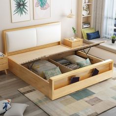 a bed with two drawers underneath it in a room next to a window and rug