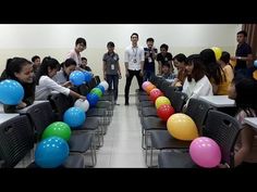 a group of people standing around each other with balloons