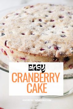 an easy cranberry cake on a glass plate with the title text overlay reads easy cranberry cake