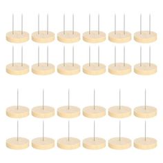 wooden dows are arranged in rows on a white background, each with different sized pins