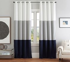 a living room with white and blue curtains