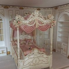 a doll house bedroom with a white bed and pink bedspread