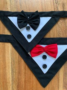 two black and white dog collars with red bow ties on top of each other