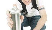 a man is holding a water bottle and posing for the camera with his hat on