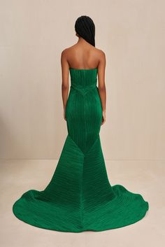 A sculpturally designed plissé strapless gown featuring a exaggerated train and artful bust. — Sculpted plissé fabric — Rose bud shaped bust details — Exaggerated train — Mermaid tail hem Plisse Fabric, Fabric Rose, Fabric Roses, Rose Bud, Swimming Bag, Strapless Gown, Autumn Sales, Candle Collection, Kids Sandals