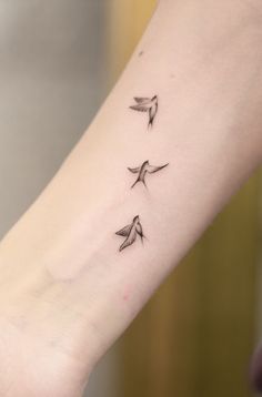 three small birds on the wrist tattoo