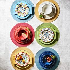 four plates with different designs on them sitting on a table