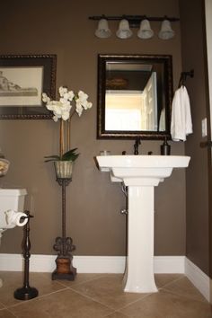 a white pedestal sink sitting next to a toilet