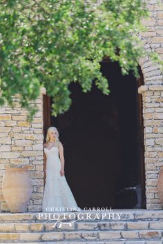 a woman in a wedding dress standing on some steps