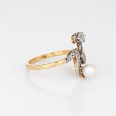 Finely detailed antique Edwardian diamond & pearl ''moi et toi'' ring crafted in 18k yellow gold (circa 1910s).    The old cushion cut diamond is estimated at 0.25 carats, accented with a further 23 estimated 0.01 carat rose cut diamonds. The total diamond weight is estimated at 0.48 carats (estimated at J-K colour and I1-2 clarity). The pearl measures 5.3mm.   The distinct and stylish ring is a great example of Edwardian era jewellery. The two stone diamond & pearl ''Moi et Toi'' design is a Fr Diamond Pearl Ring, Wedding Ring Guard, Ring Guard, Platinum Wedding Band, Cushion Cut Diamond, Pearl And Diamond Ring, Platinum Wedding, Stylish Rings, Silver Tops