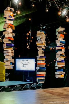 a room filled with lots of books stacked on top of each other in front of a tv