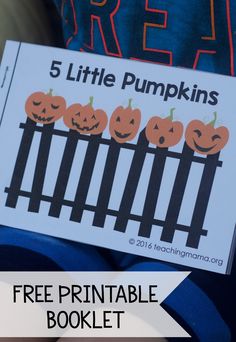 a little boy holding up a free printable book about pumpkins with the title, 5 little pumpkins