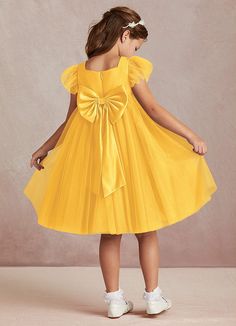 Kalio is our adorable tulle and matte satin flower girl dress. She features a square neckline that is framed with charming short flutter sleeves. She has an empire waist that offers comfort and ease of movement. The flowy A-line skirt adds whimsy while the removable bow gives this dress versatility. Yellow Flower Girl Dress, Yellow Flower Girl Dresses, Satin Flower Girl Dress, Tulle Flower Girl, Marigold Flower, Flower Girl Dresses Tulle, Satin Flowers, Matte Satin, Flower Girl Dress