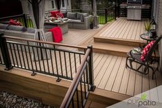 a deck with chairs, table and grill on it