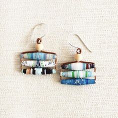 the earrings are made out of books and beads