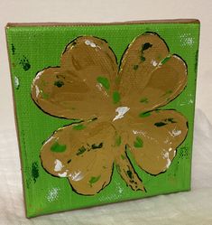 a painting of a four leaf clover on a green background