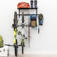 there is a bike that is parked next to a rack with many items on it