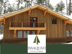 a log cabin with balcony and balconies on the front porch is surrounded by pine trees