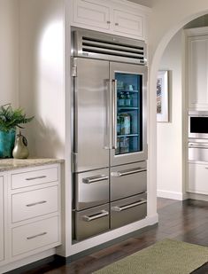 a stainless steel refrigerator in a white kitchen