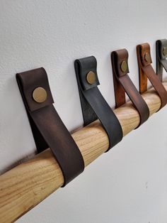 a row of wooden handles on a white wall