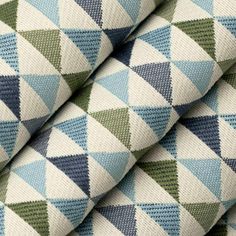 a close up view of a blue, green and white checkered pattern on fabric