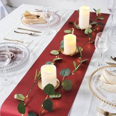 the table is set with candles and place settings